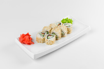 Sushi roll "Geisha" with rice, fish, cucumber, wasabi, sesame and pink ginger. White plate on a white background.