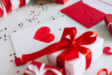 One toddler boy draws a card with a heart on Valentine's day, to his mother on Mother's day.