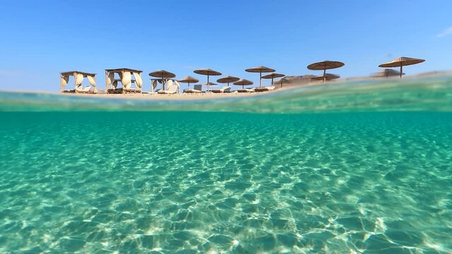 Underwater split video of paradise beach of Simos in island of Elafonisos, Lakonia, Greece