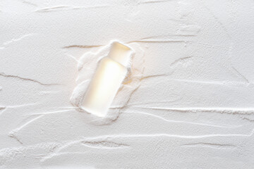 Artistic background, texture of sand and plaster with bottle print. Color white