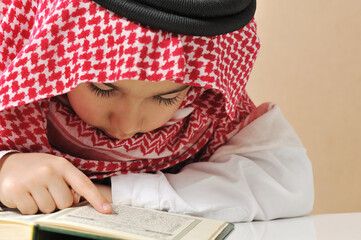 Muslim boy reading Koran. High quality photo