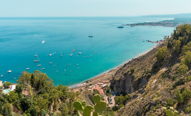 High view of turquoise Mediterranean sea in Taormina, Sicily, Italy during a summer day