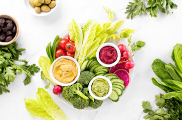 Fresh green veggie charcuterie platter with various dips