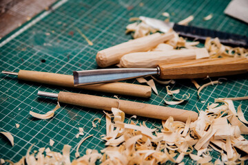 The tools are on the desktop in a carpentry or homemade workshop. Dust and shavings scatter in the air.Workplace.