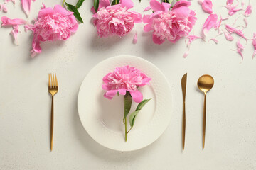 Obraz na płótnie Canvas Elegance summer table setting with pink peony flowers on white background. View from above. Space for text.