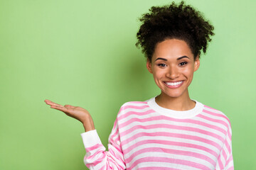 Photo of nice glad lady palm presenting empty space tips wear striped shirt isolated green color background