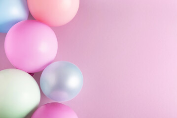 Birthday party, celebration background. Balloons on pastel pink surface. Top view, flat lay, copy space