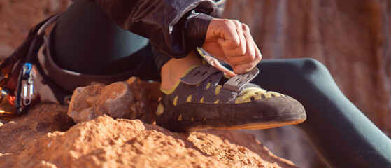 Girl is wearing climbing shoes, closeup view.
