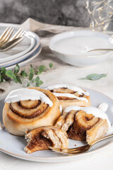 Cinnamon rolls or cinnabon  with icing for Christmas. Homemade traditional winter festive dessert buns. Pastry food for breakfast on white background