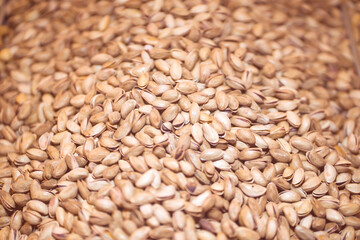 Lots of pistachios, background with tasty nuts.