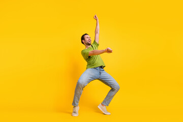 Fototapeta na wymiar Full size profile side photo of young man have fun ride horse look empty space isolated over yellow color background
