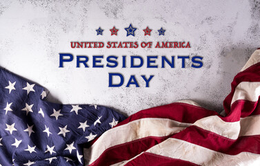 Happy presidents day concept with flag of the United States and the text on dark stone background.