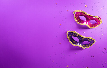 Happy Purim carnival decoration concept made from mask and sparkle star on purple background....
