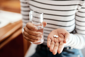 For when youre not feeling quite right. Cropped shot of a woman taking her medication at home.