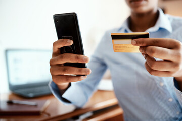 Keep things moving with the power of credit. Cropped shot of a businesswoman using a smartphone and credit card.