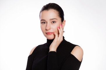 Fototapeta premium Woman with short hair and clean skin. Face close up, skin beauty tanned, beautiful smile woman in black turtleneck over white background