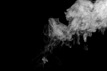 Beautiful abstract cloud of smoke isolated on black background. White smoke glow in the dark, steam gushing to form free shapes.