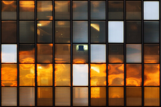 Sunrise reflexion on glass tower in Paris suburb