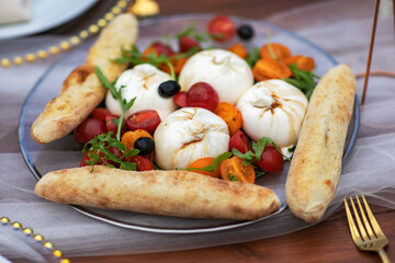 Suluguni sulguni cheese with tomatoes on white background. snack food