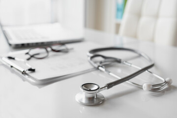 Doctor office desk, workplace of physician therapist with stethoscope closeup, Health care, medicine concept. - obrazy, fototapety, plakaty
