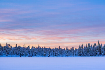 Fototapeta premium Torassieppi winter landscape on the frozen lake at sunset, Lapland, Finland