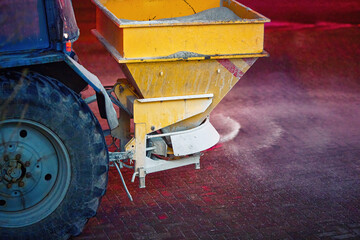 Tractor  spread salt reagent, de-icing street. Municipal service melt ice. Salt spreader, tactor...