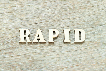 Fototapeta na wymiar Alphabet letter in word rapid on wood background