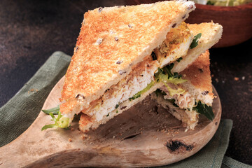 Chicken sandwich with lettuce and whole grain bread. 