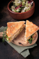 Chicken sandwich with lettuce and whole grain bread. 