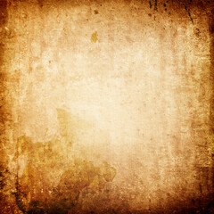 Old grunge background of worn yellowed stained paper