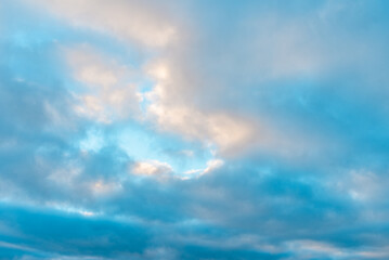 Naklejka na ściany i meble Beautiful sun leaving bright golden shades. clouds in sky winter evening.