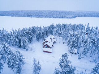 Torassieppi Reindeer Farm Accommodation showing cabins in the woods inside the arctic circle in Finnish Lapland, Finland drone