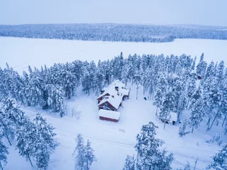 Tuinposter Torassieppi Reindeer Farm Accommodation showing cabins in the woods inside the arctic circle in Finnish Lapland, Finland drone © Matthew