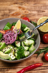 salad mix with avocado and cucumber, with balsamic dressing