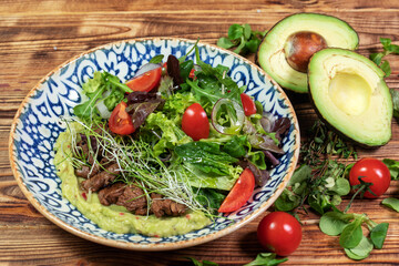 salad mix with avocado and cucumber, with balsamic dressing