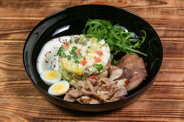 Olivier salad. Traditional russian appetizer for celebrating new year eve and christmas. White wooden table background. Festive table setting. Fir tree branches, golden stars and balls.