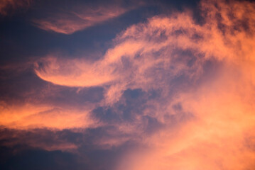 Amazing bright orange, purple and pink dramatic sunset clouds in the sky inside the Arctic Circle in Lapland, Finland