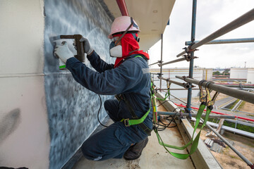 A male worker at high test steel tank butt weld  carbon shell plate of storage tank crude oil