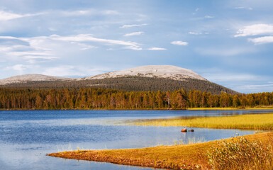 Late summer landscape in Lapland. Fells and a lake. Sunny day.