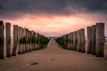 Breakwaters lead you into the North Sea during the sunset in the city of Domburg in the Netherlands