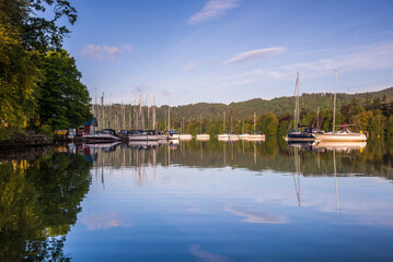 Sailing boats reflecting in Lake Windermere at sunrise, Lake District National Park, Cumbria, England, UK, Europe