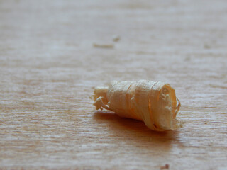 Fresh shavings close-up on a wooden surface