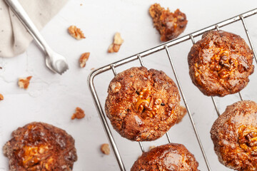 Homemade cookies with walnuts on a grid.