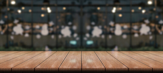 Empty wood table top with lights bokeh on blur coffee shop background.