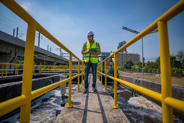 Worker under checking the waste water treatment pond industry large to control water support...