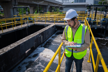 Worker under checking the waste water treatment pond industry large to control water support...