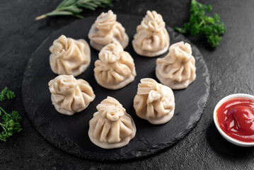 Khinkali, Georgian dumplings with meat filling on a stone background
