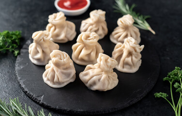 Khinkali, Georgian dumplings with meat filling on a stone background