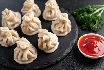 Khinkali, Georgian dumplings with meat filling on a stone background