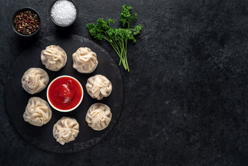 Khinkali, Georgian dumplings with meat filling on a stone background